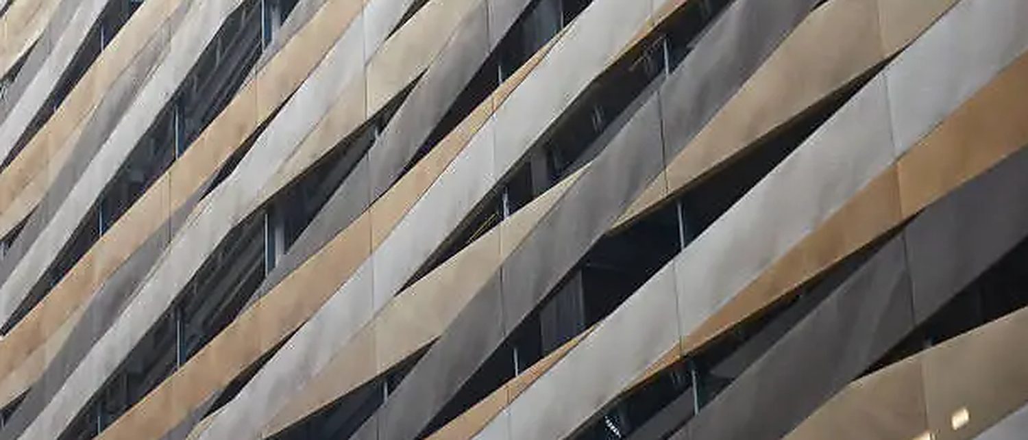 New anthracite grey wall cladding being installed on a commercial elevation